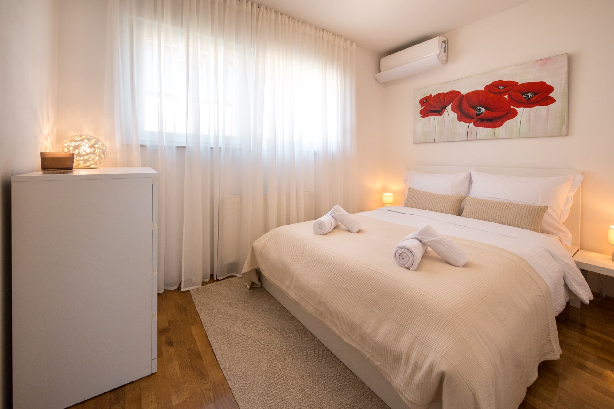 Second double bedroom with fresh towels, air conditioning and a wide window